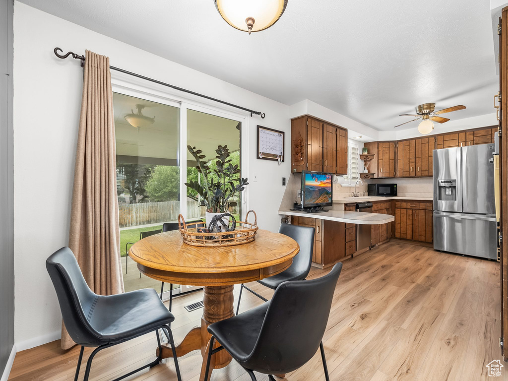 Dining room with light wood-type flooring and ceiling fan