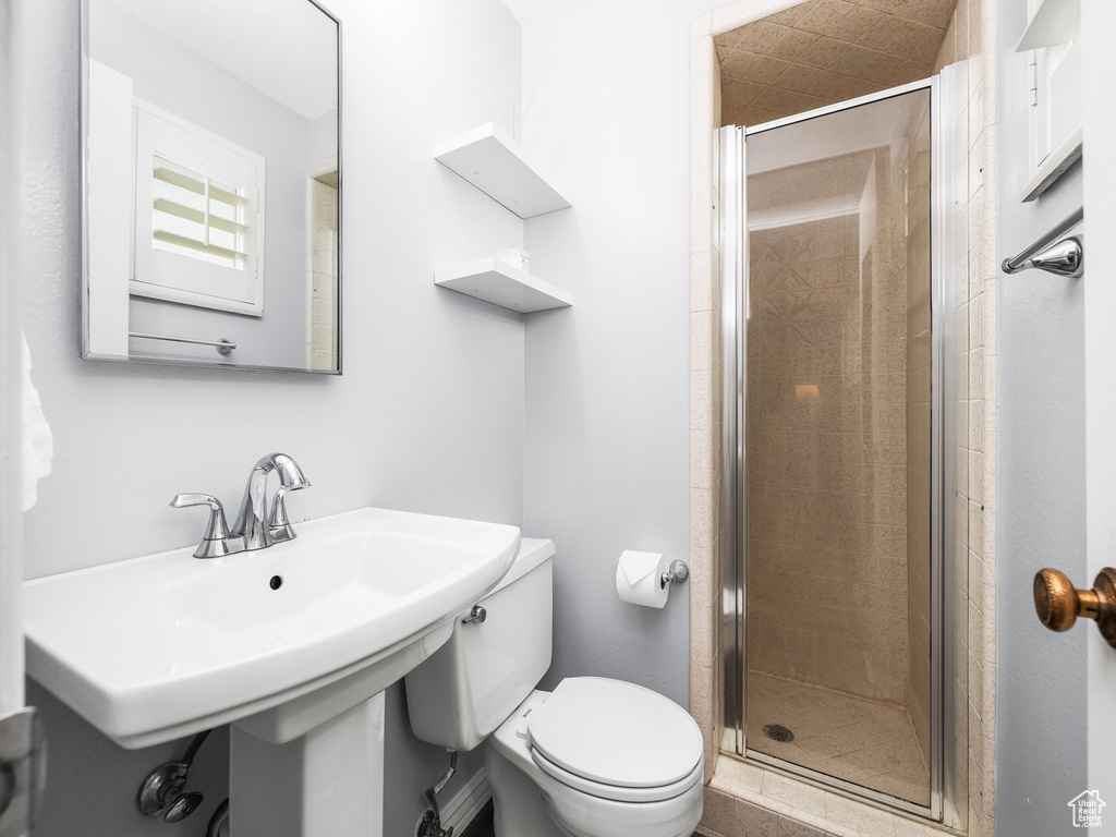 Full bath featuring toilet and a shower stall