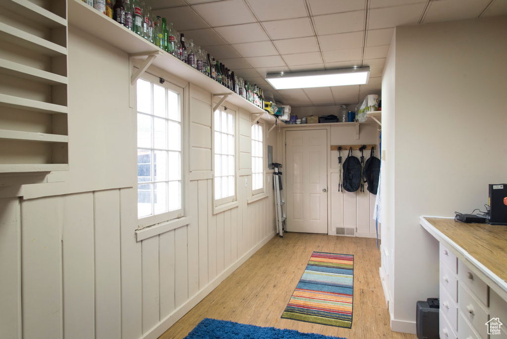 Entryway with light wood-style flooring and a paneled ceiling