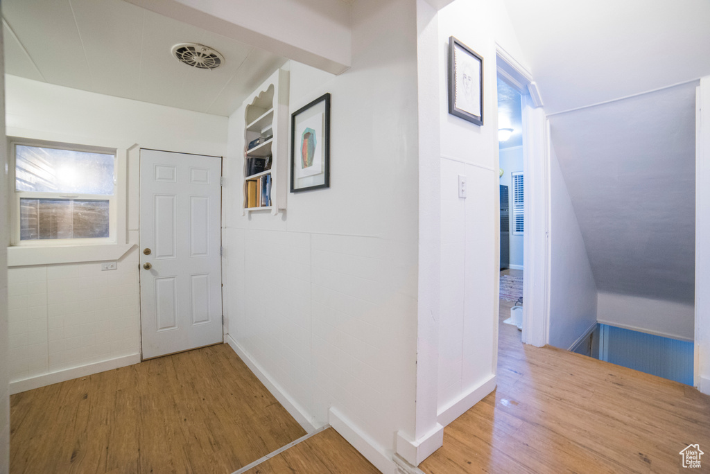 Corridor with wood finished floors and baseboards