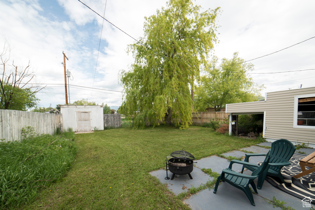 View of yard featuring an outdoor fire pit and a patio area