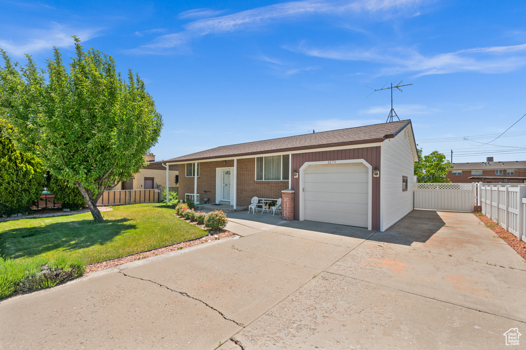 View of front of home with an attached garage, concrete driveway, and brick siding