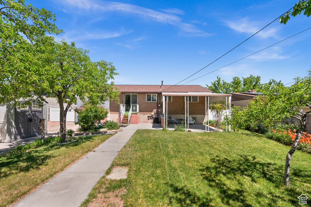 Back of property with brick siding and a gate