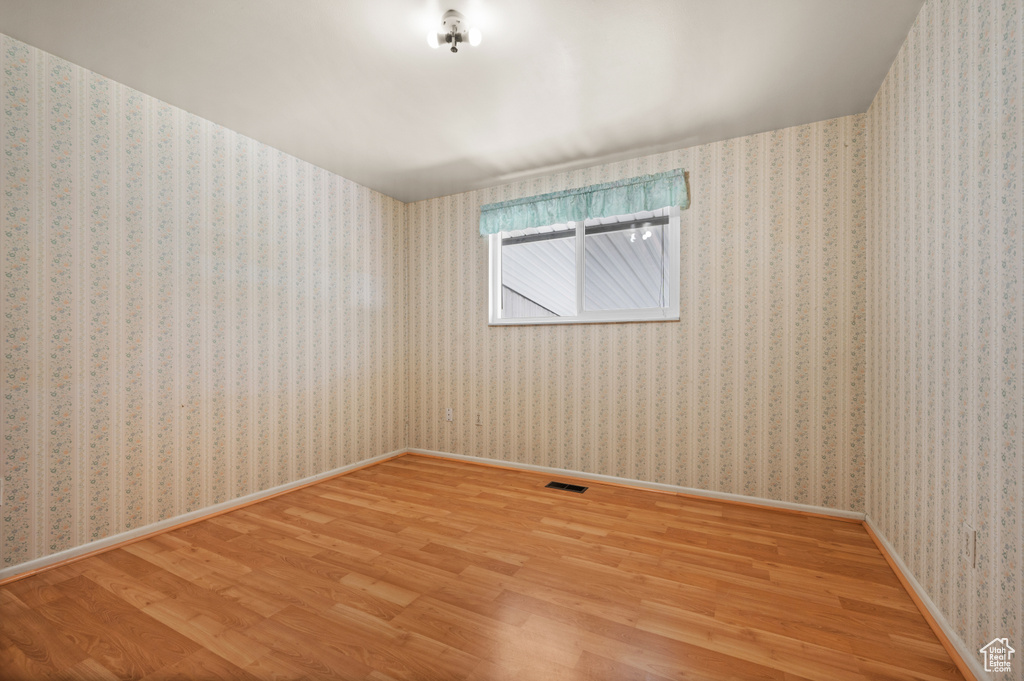 Spare room with wood finished floors and baseboards