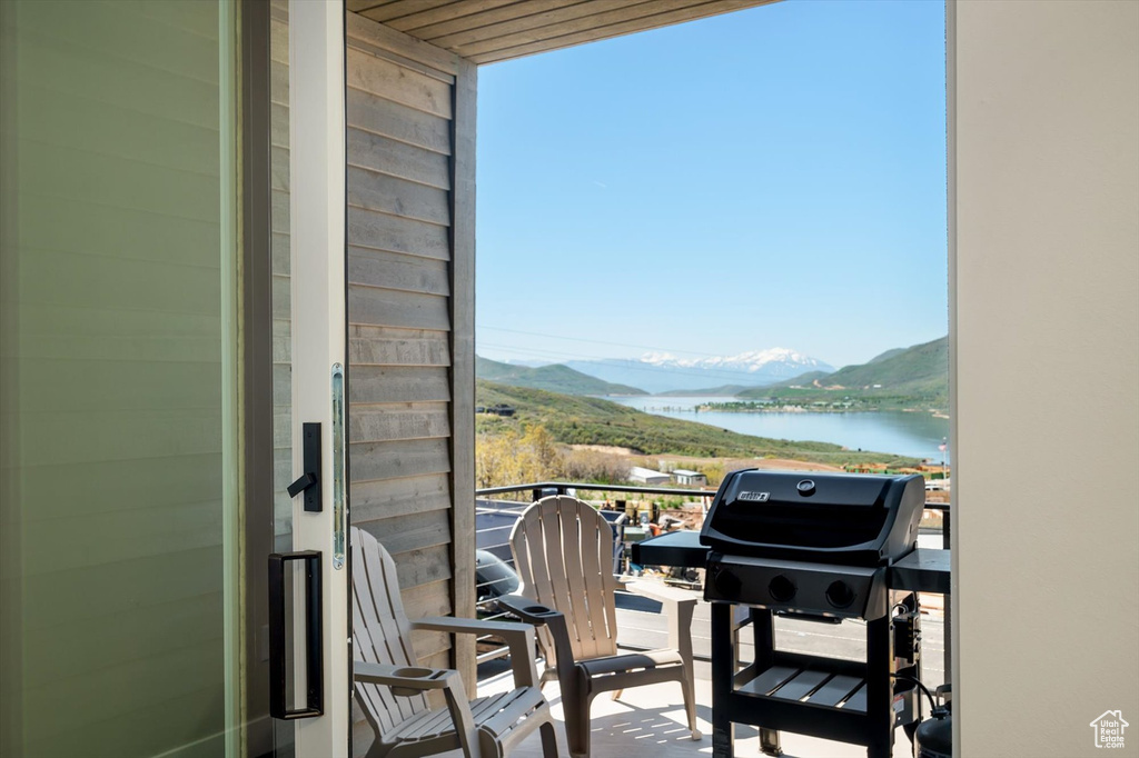 Balcony with a grill and a water and mountain view