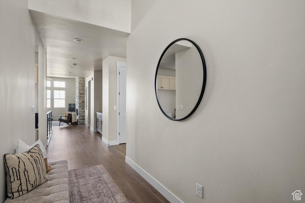 Hall featuring baseboards and dark wood-style floors