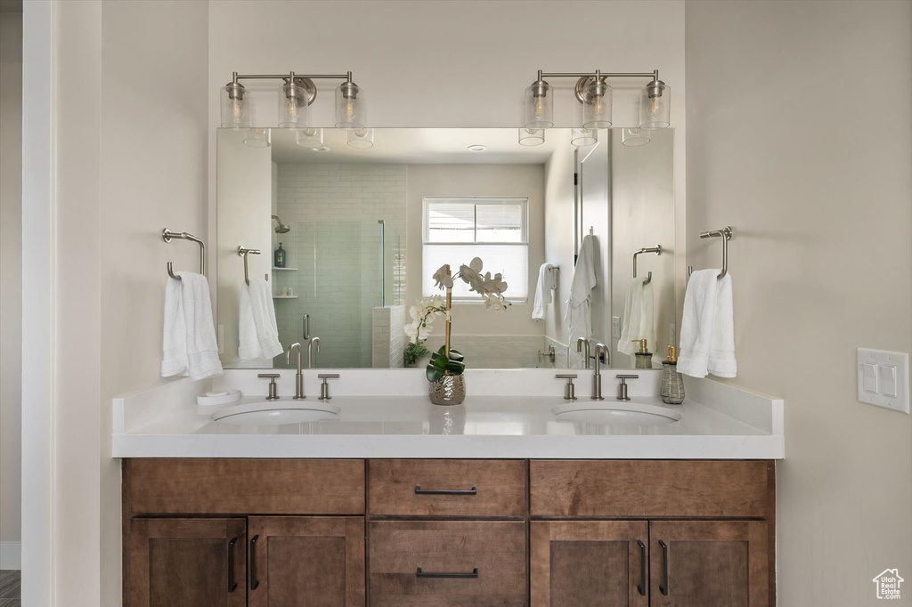 Bathroom featuring double vanity and a stall shower