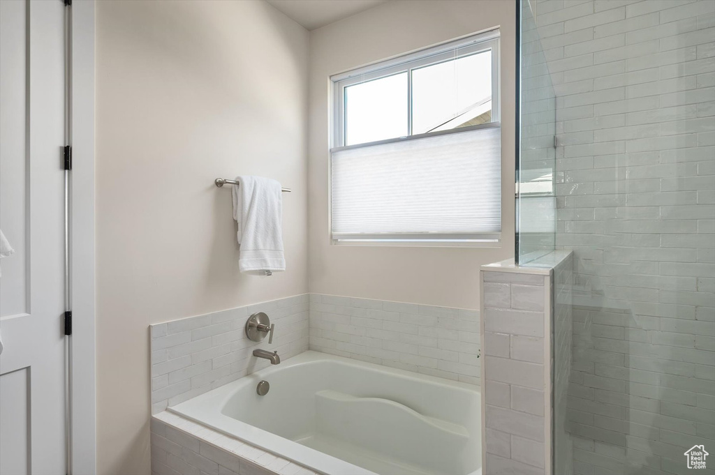 Full bathroom with a garden tub and a stall shower
