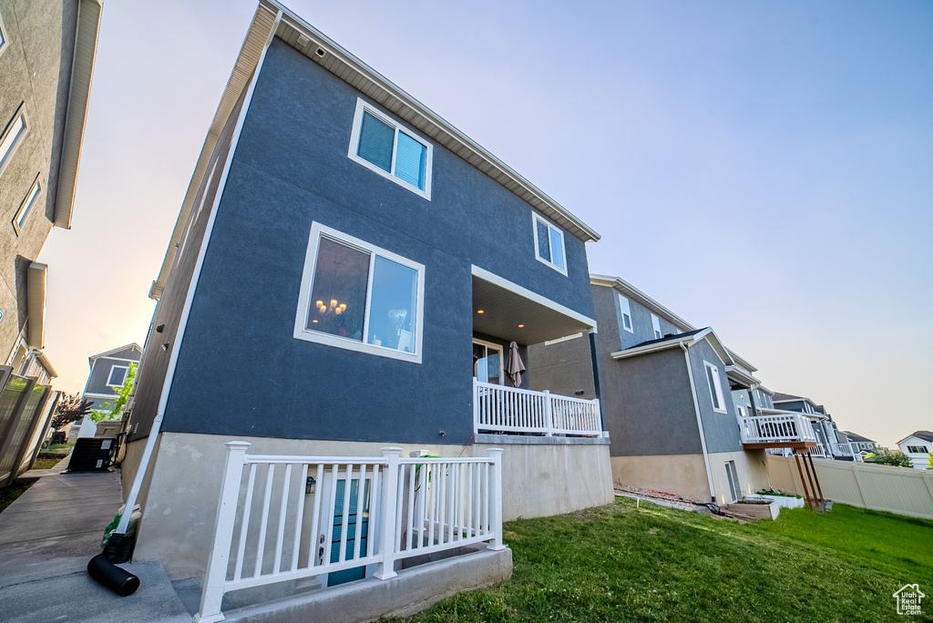 Back of property featuring a residential view and stucco siding