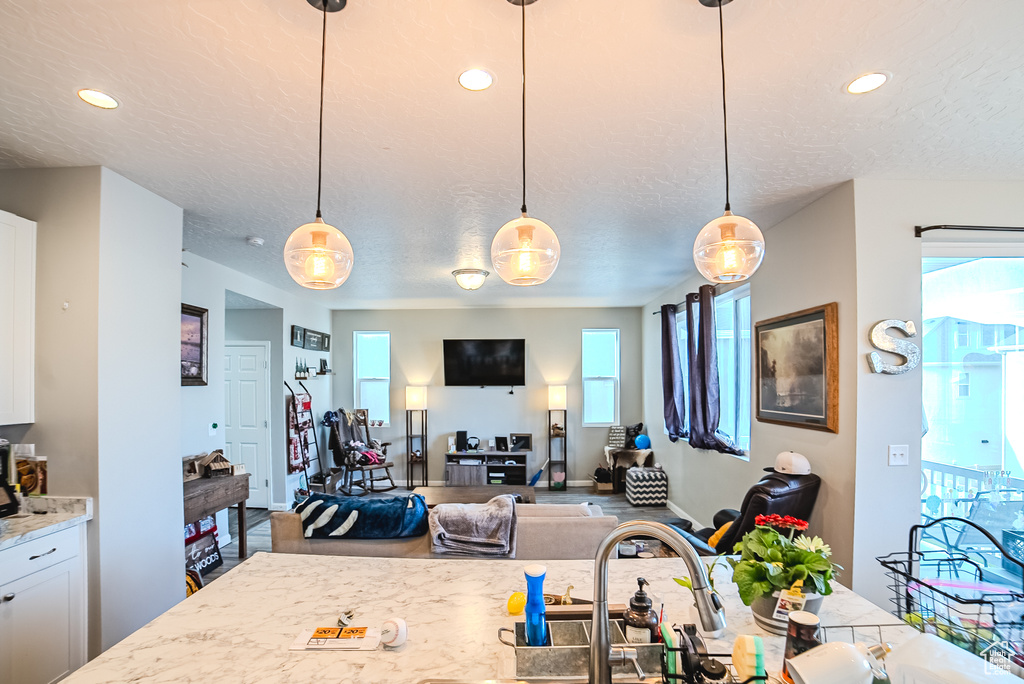 Dining space featuring a textured ceiling, recessed lighting, and baseboards