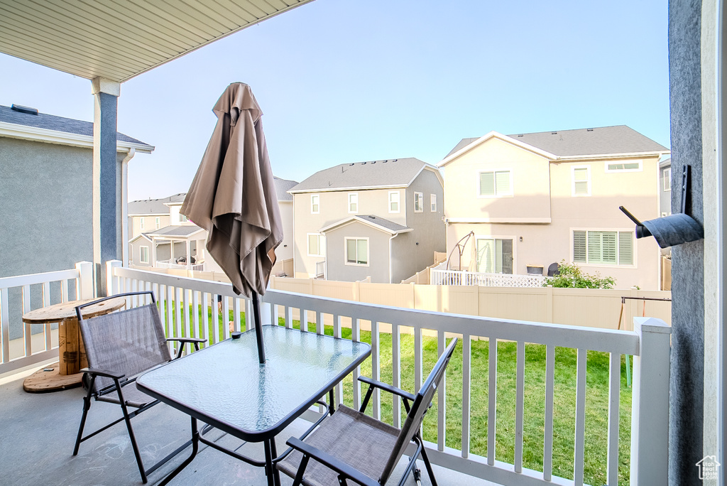 Balcony featuring a residential view and outdoor dining space