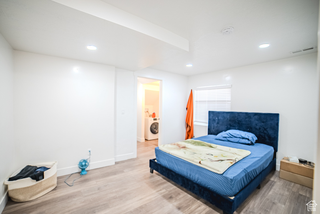 Bedroom with washer / clothes dryer, light wood finished floors, recessed lighting, and baseboards