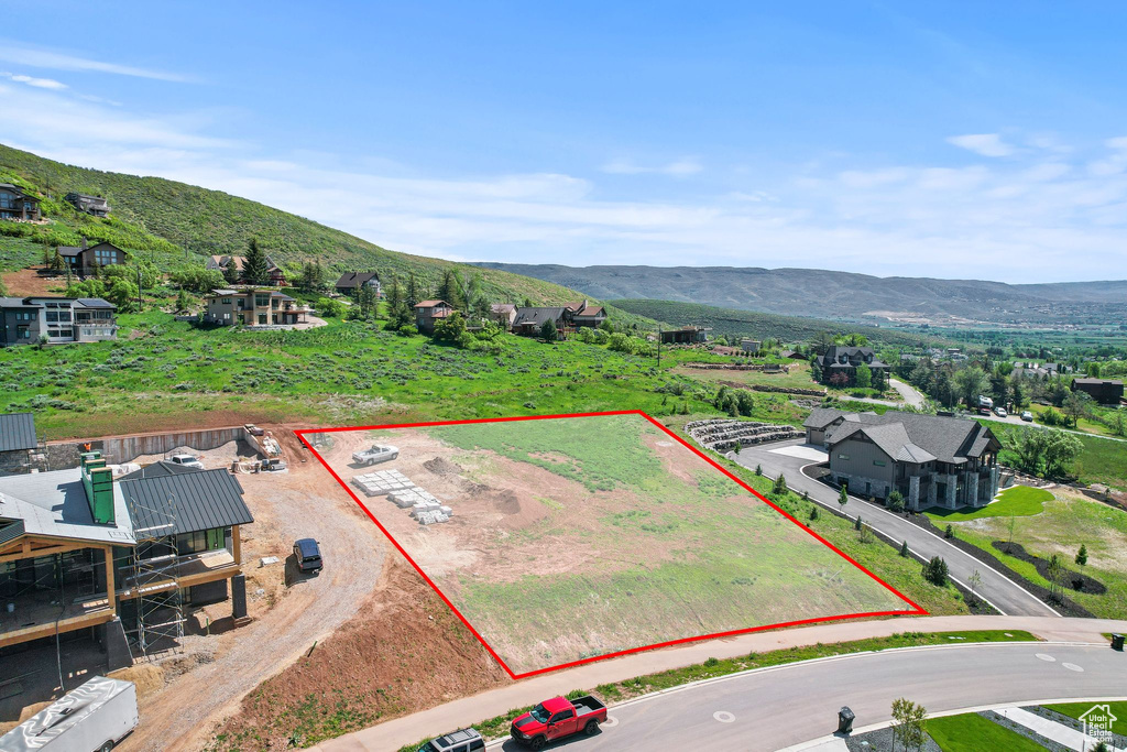 Aerial view of property's location featuring property boundaries highlighted and a mountain backdrop