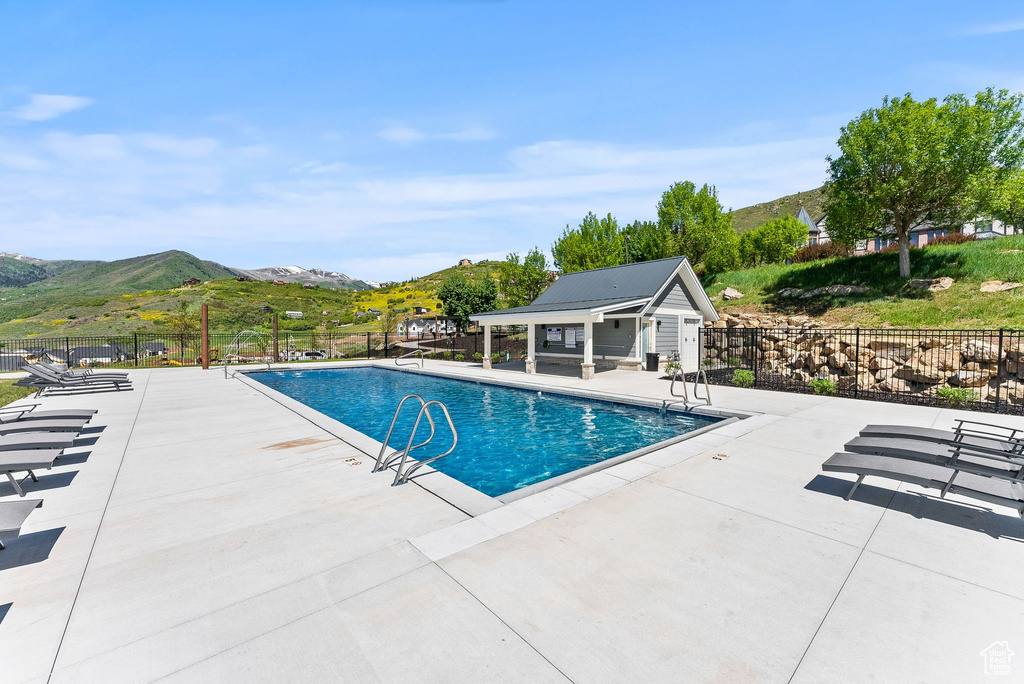 Community pool with a mountain view and a patio