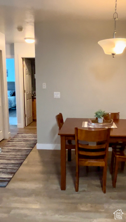 Dining space with wood finished floors and baseboards