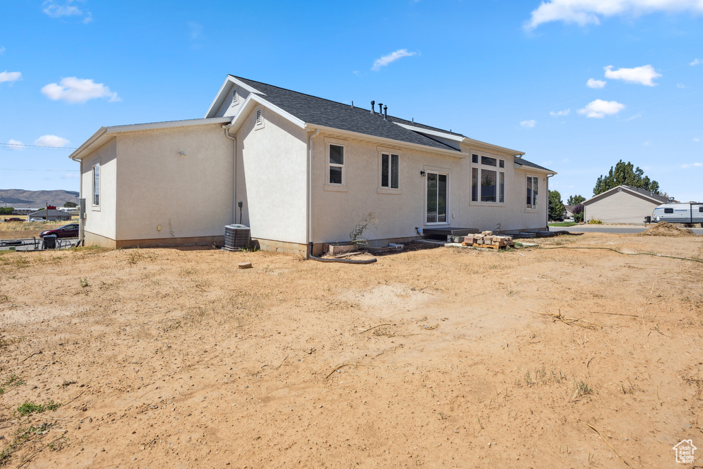 Back of property featuring stucco siding
