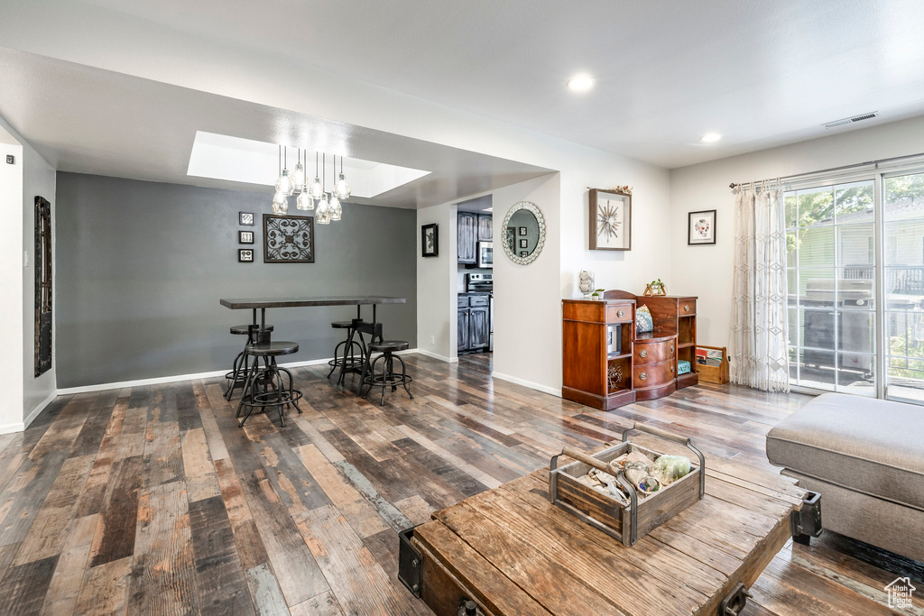 Living area featuring hardwood / wood-style floors, recessed lighting, baseboards, and a chandelier