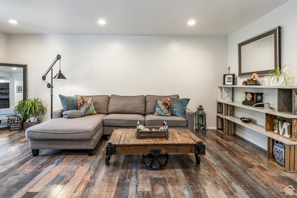 Living area with wood-type flooring and recessed lighting