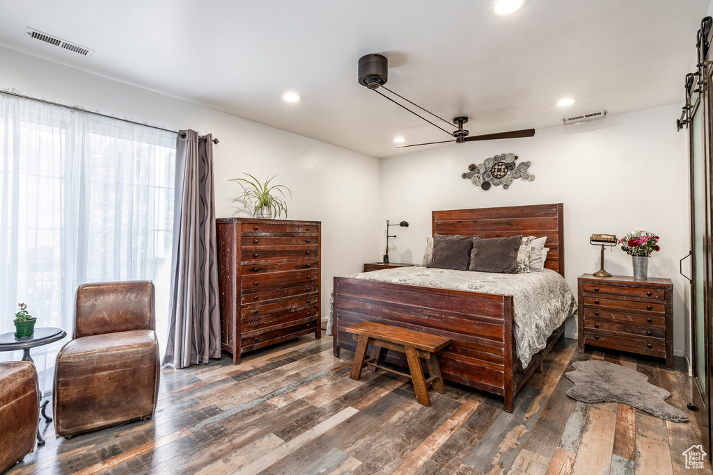 Bedroom with wood finished floors, recessed lighting, and ceiling fan