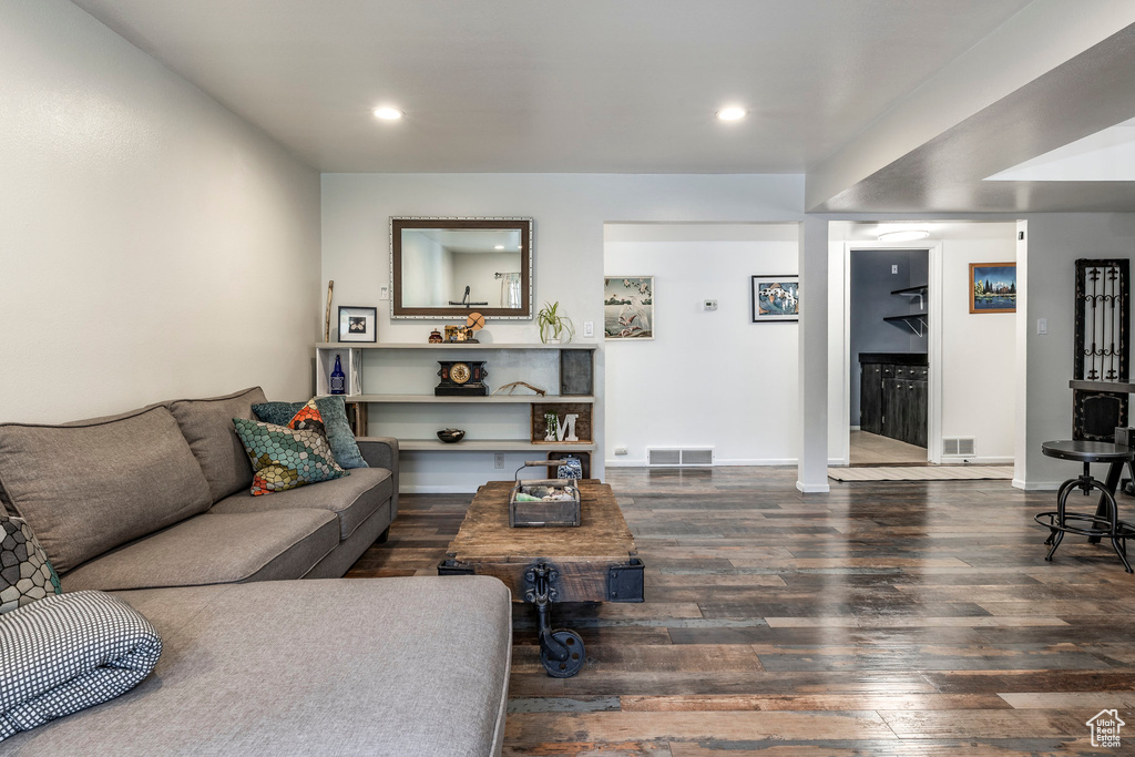 Living area featuring wood finished floors, recessed lighting, and baseboards