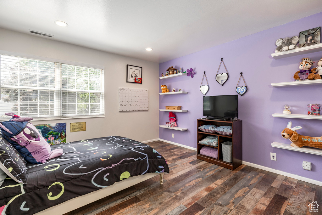 Bedroom with wood finished floors, baseboards, and recessed lighting