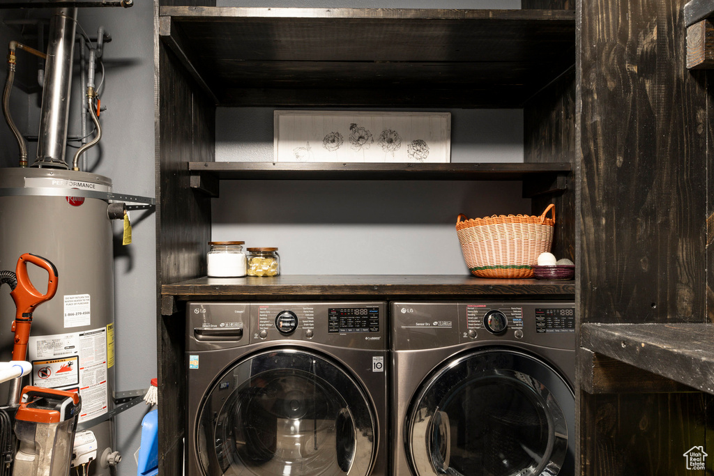 Laundry room featuring water heater and independent washer and dryer