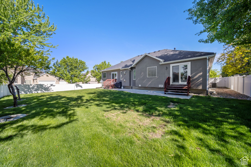 Back of house featuring entry steps, a patio area, and stucco siding