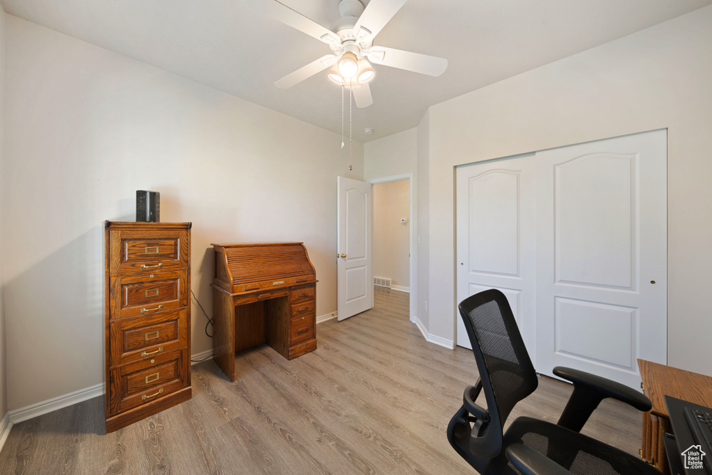 Office space with light wood-type flooring, baseboards, and ceiling fan
