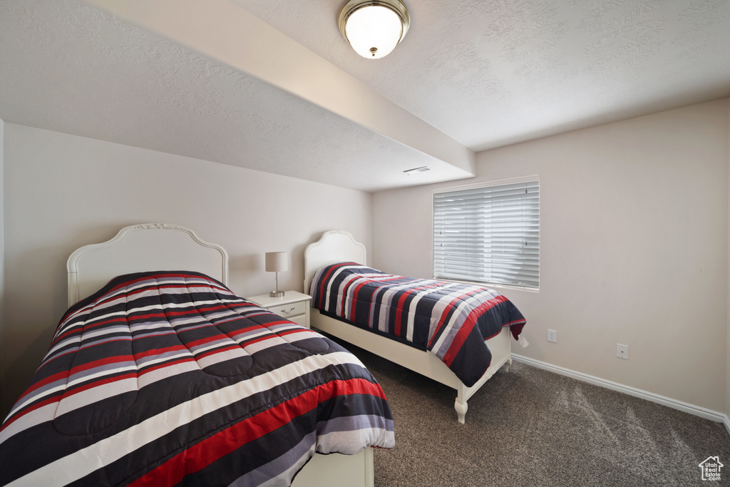 Bedroom with carpet flooring and baseboards