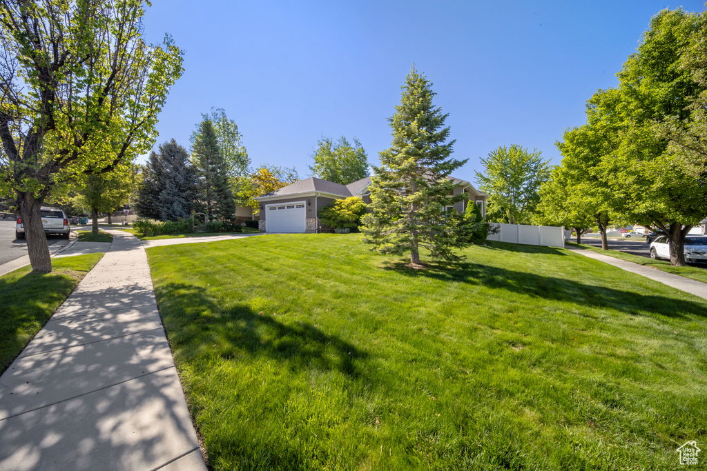 View of front facade featuring an attached garage and driveway