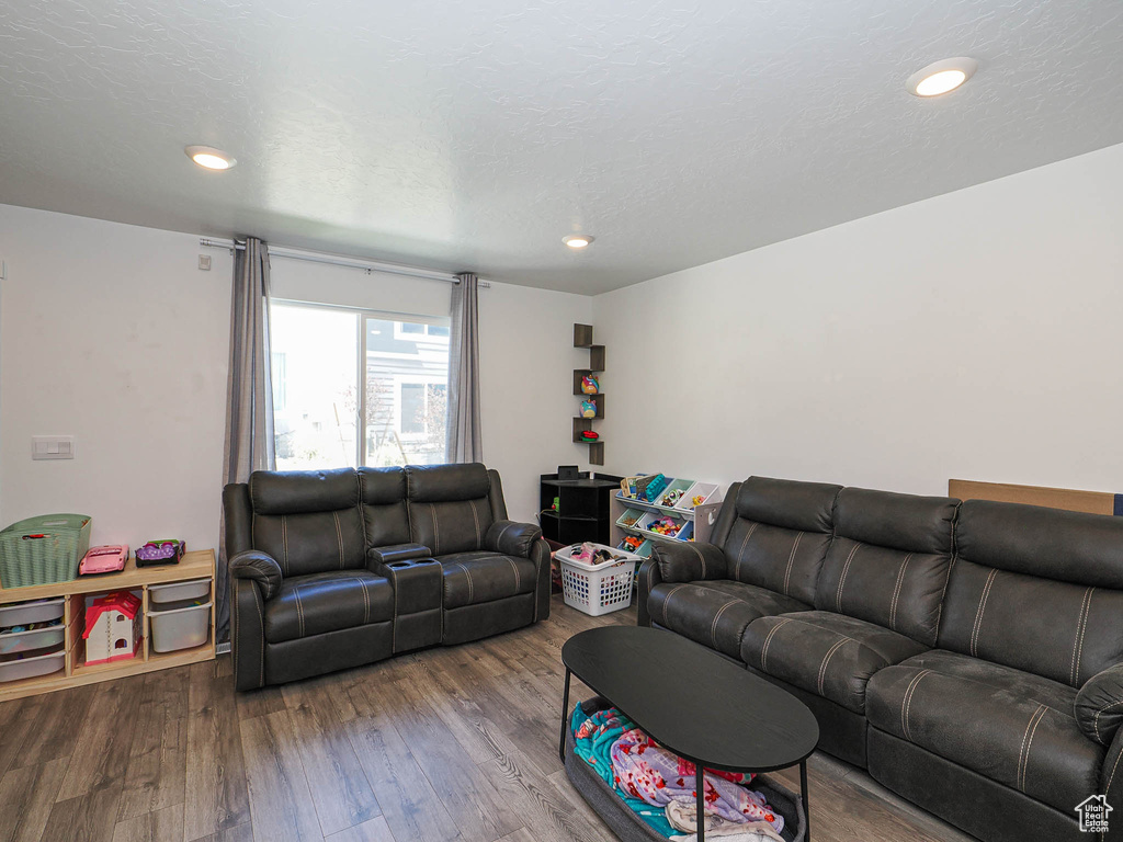 Living area with wood finished floors and recessed lighting