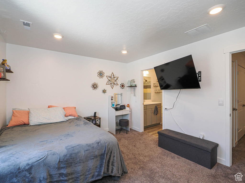 Bedroom featuring carpet flooring, baseboards, recessed lighting, and ensuite bathroom
