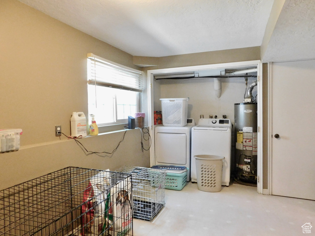 Washroom with water heater, washing machine and dryer, and carpet flooring