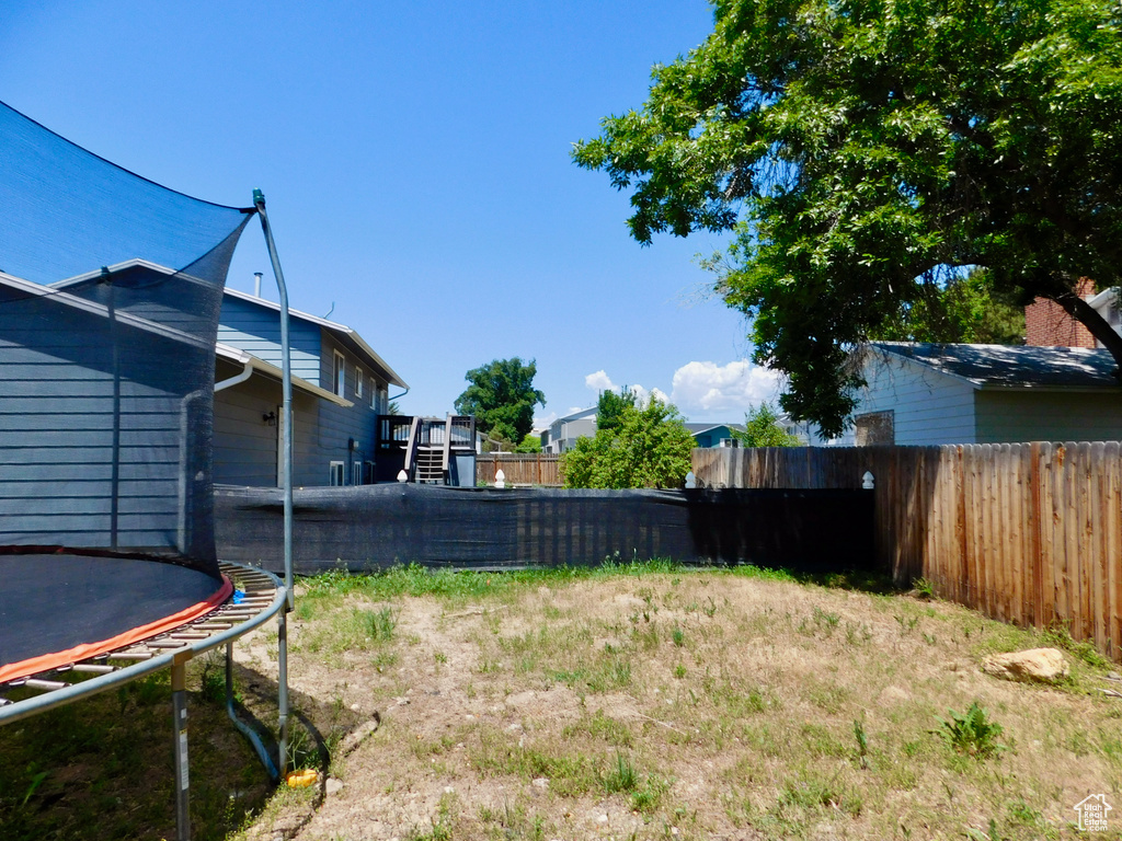 View of yard with a trampoline