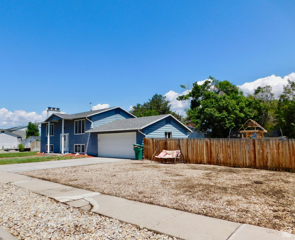 View of front of house featuring a garage and concrete driveway