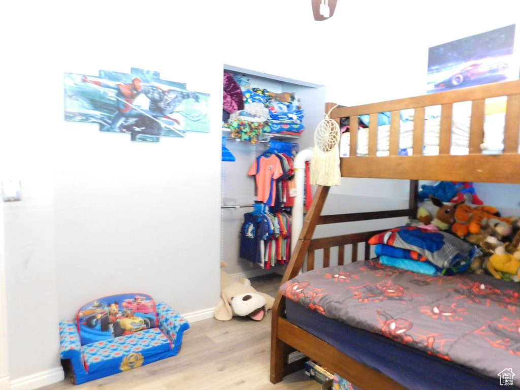 Bedroom featuring wood finished floors, baseboards, and ceiling fan