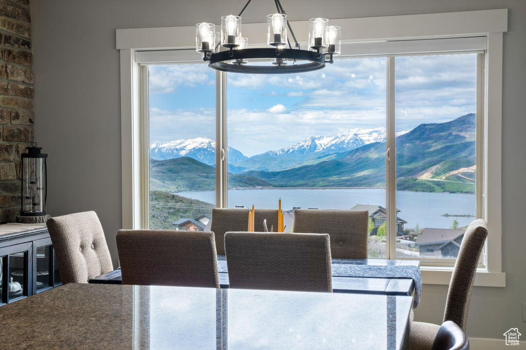 Dining room featuring a chandelier and a water and mountain view