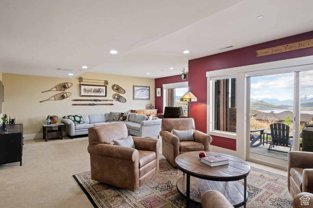 Living room featuring recessed lighting, light colored carpet, and a mountain view
