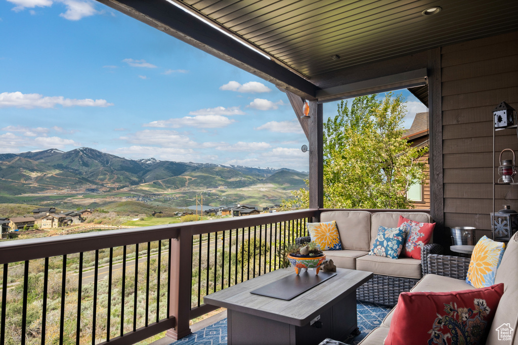 Wooden terrace featuring outdoor lounge area and a mountain view