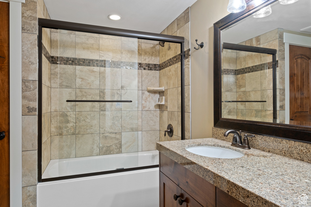 Full bathroom featuring vanity, enclosed tub / shower combo, and recessed lighting