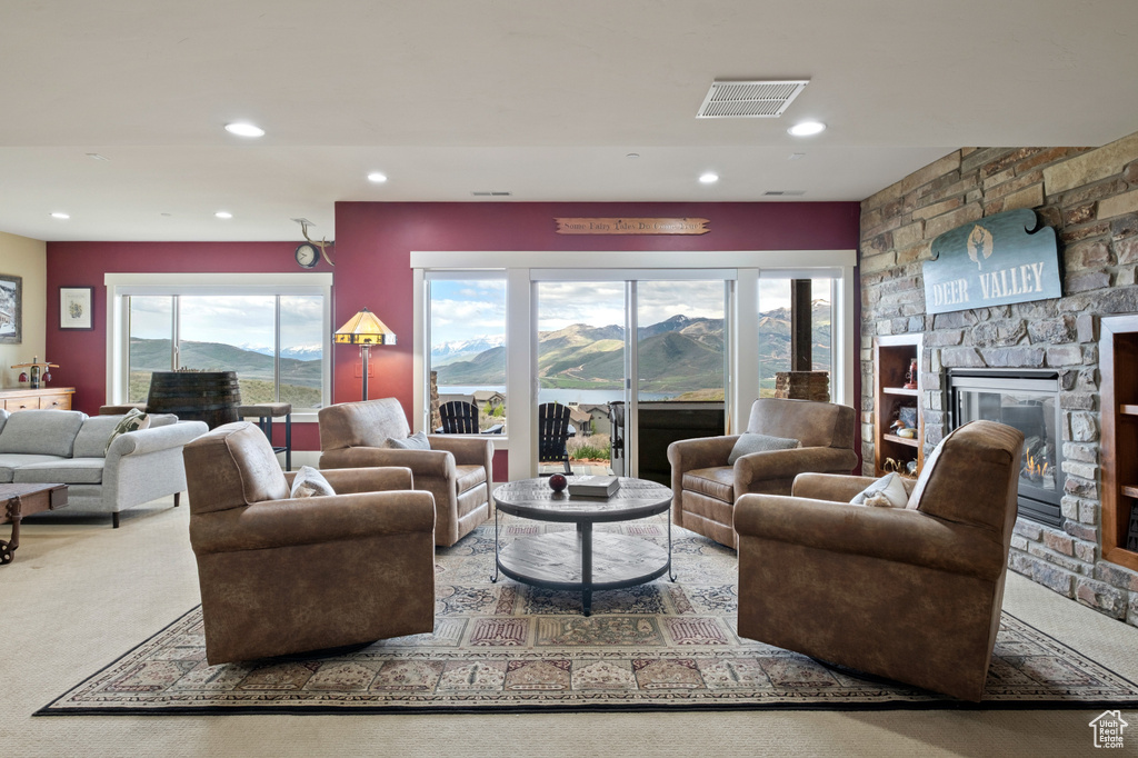Carpeted living room featuring a fireplace and recessed lighting