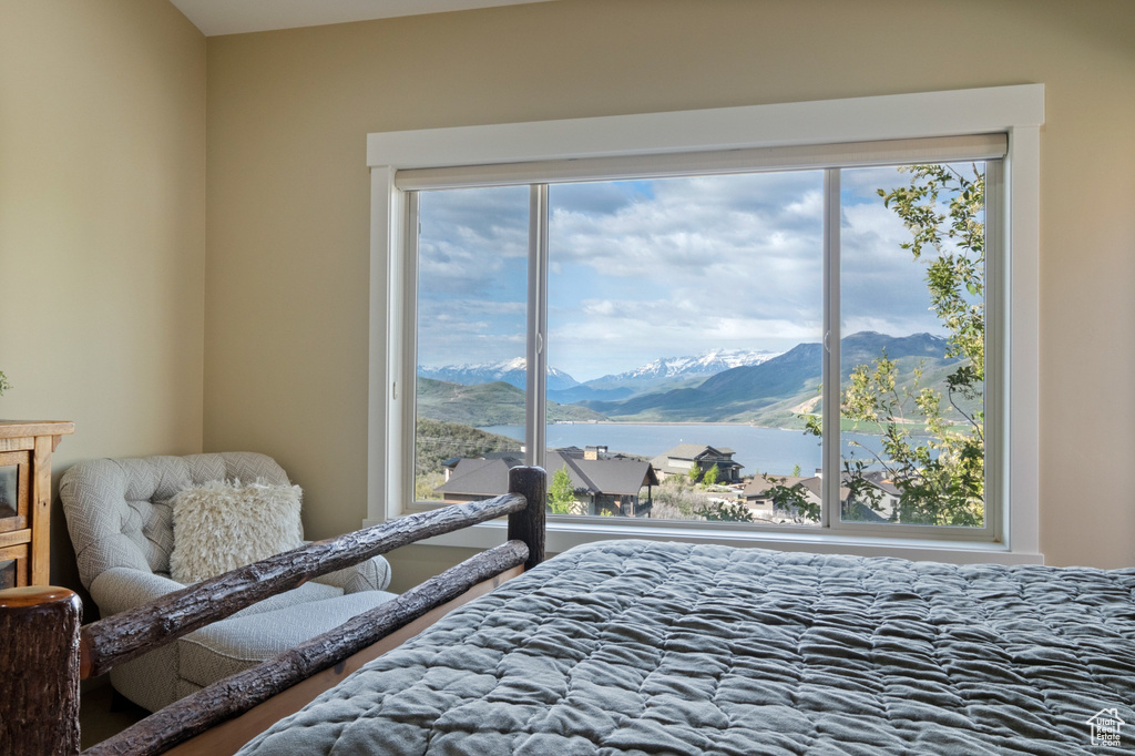 Bedroom with a water and mountain view