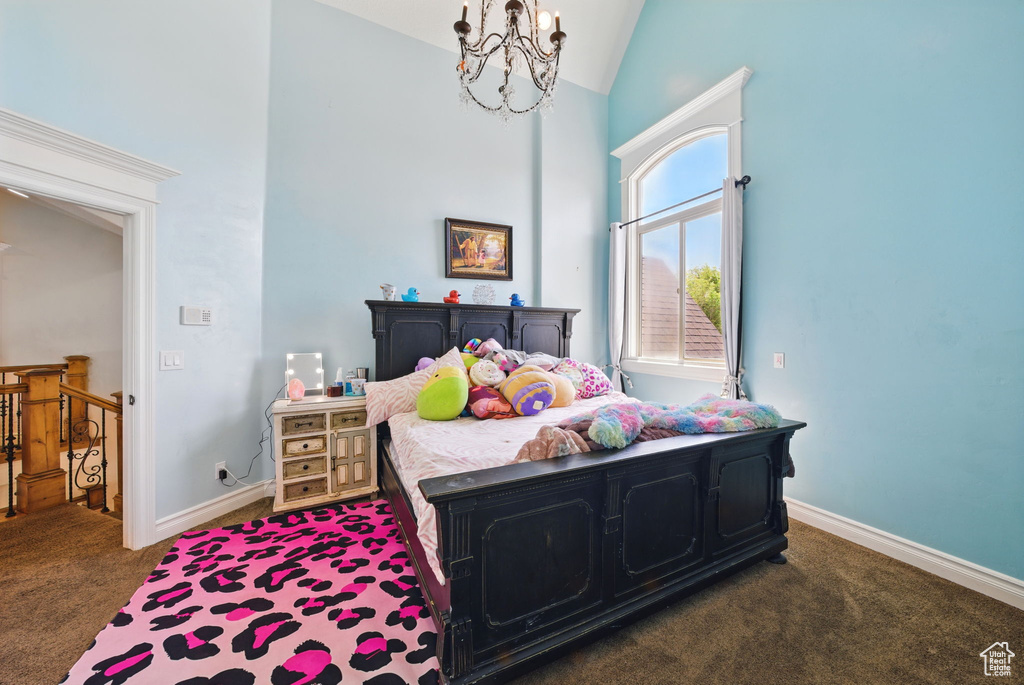Bedroom featuring carpet, high vaulted ceiling, a chandelier, and baseboards