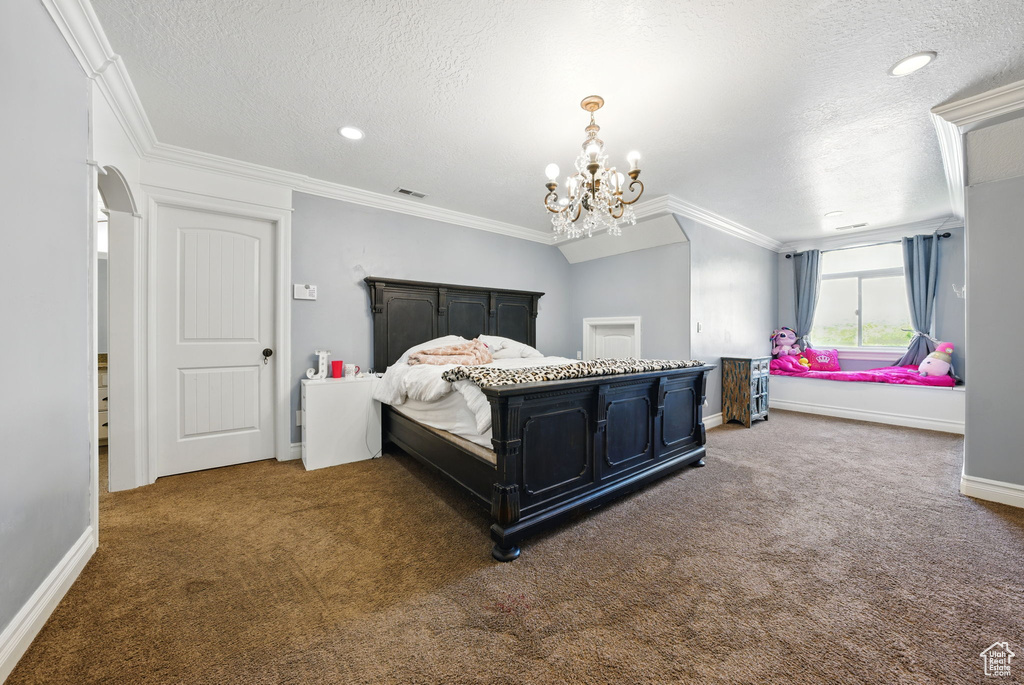 Carpeted bedroom with a textured ceiling, crown molding, baseboards, a chandelier, and recessed lighting