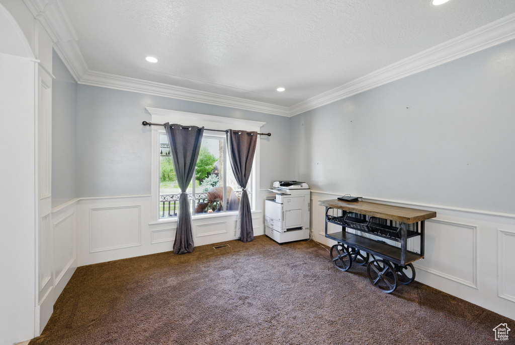 Carpeted office with ornamental molding, wainscoting, a decorative wall, and recessed lighting