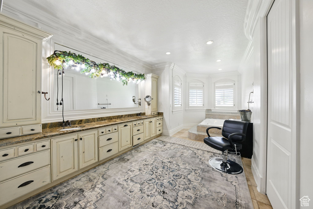 Full bathroom featuring crown molding, double vanity, baseboards, a bath, and recessed lighting