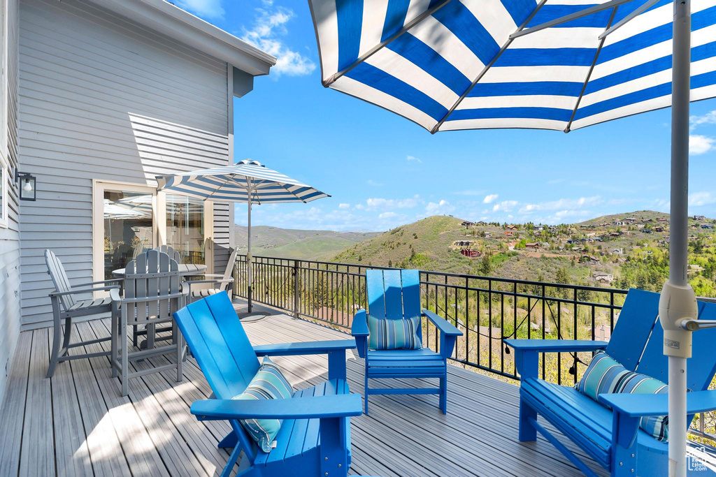 Deck with a mountain view and outdoor dining space