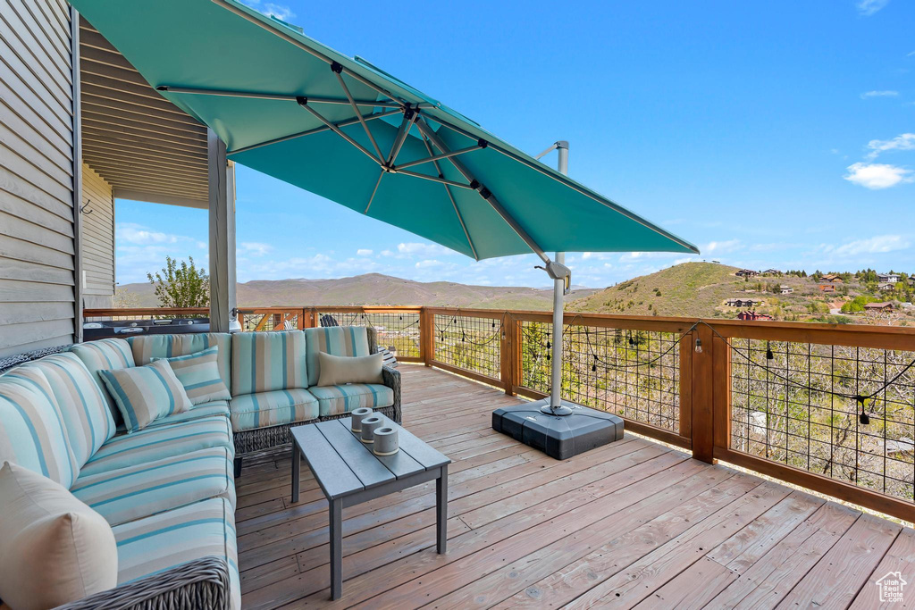 Wooden deck featuring an outdoor living space and a mountain view