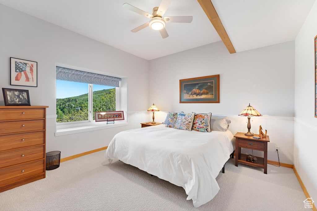Carpeted bedroom with baseboards and ceiling fan