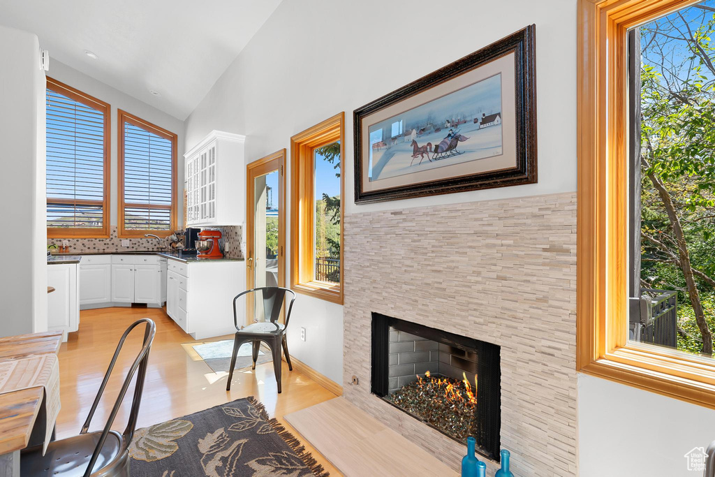 Dining room featuring light wood-style flooring and a fireplace with flush hearth